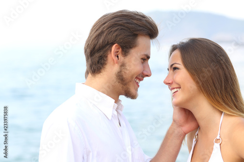 Romantic couple ready to kiss on the beach