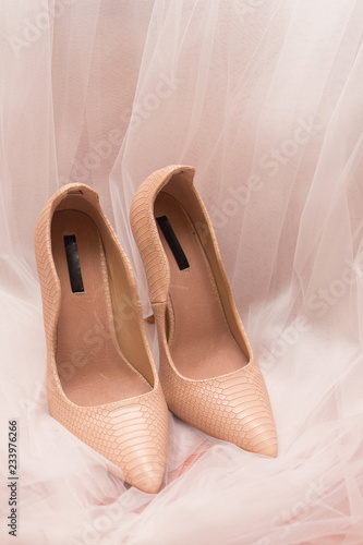 Wedding shoes and white wedding or bridal veil