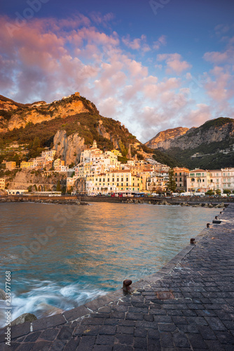 view to pier and harbor with Amalfi coast in Italy in sunset with clouds