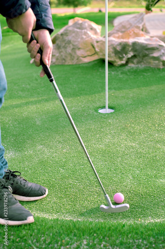 Golf ball and Golf Club on Artificial Grass. photo