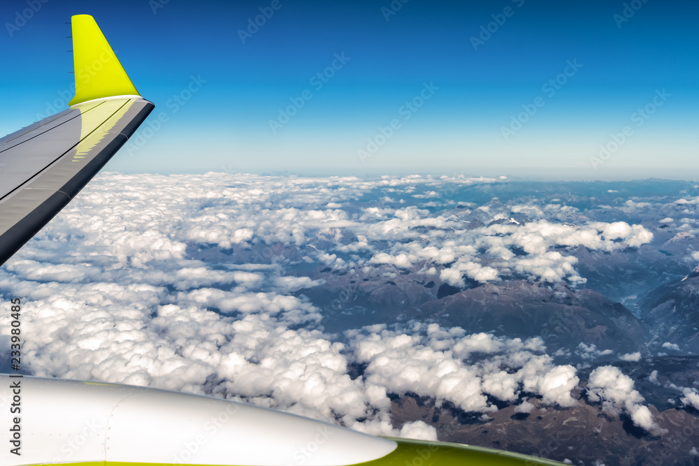 Aerial view of cloudy sky horizon over the Alps with wing of airplane. Aerial view of cloudy sky horizon over the Alps with wing of airplane.