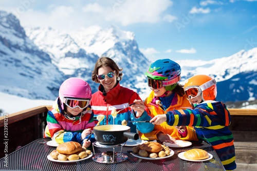 Family apres ski lunch in mountains. Skiing fun. photo