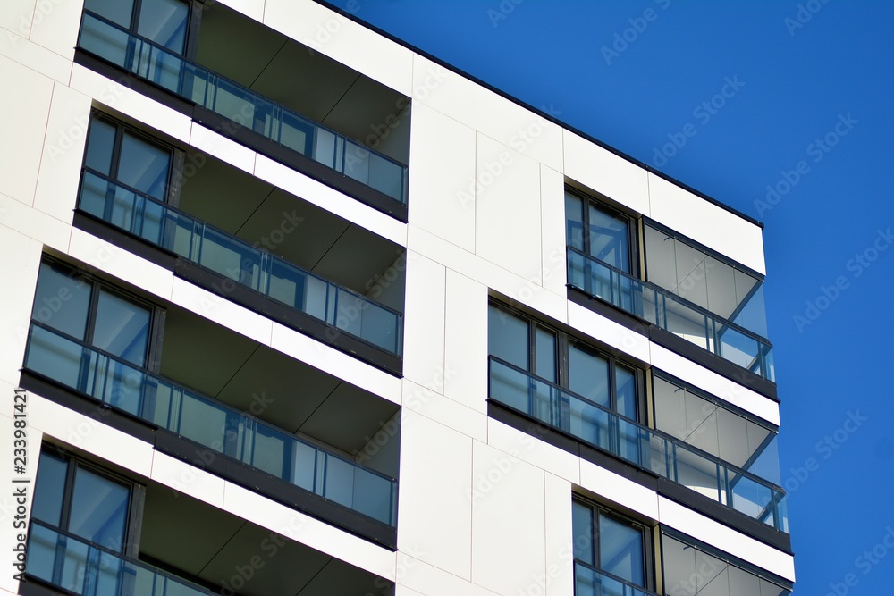 Fragment of a facade of a building with windows and balconies. Modern home with many flats. Fragment of a facade of a building with windows and balconies. Modern home with many flats.