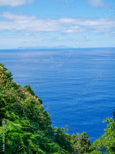 Image of island view on the sea with sailing boat