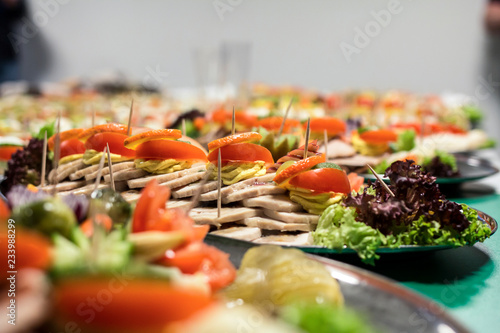 Lots of club sandwiches on plates, served at a corporate event