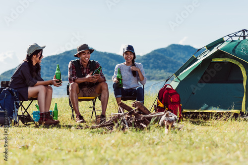 Camping camp in nature happy friends party and drinking beer together in summer a