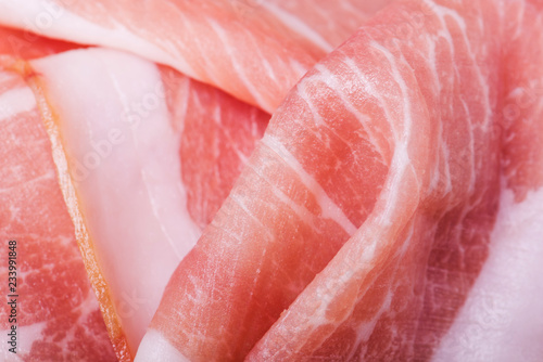 Fresh sliced prosciutto closeup. Can be used as a background.