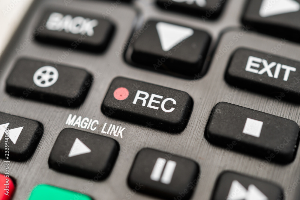 Close up macro photography of a smart tv television remote control with recording button. Concept of show, business, recording, tv, action, and radio Close up macro photography of a smart tv television remote control with recording button. Concept of show, business, recording, tv, action, and radio