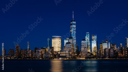 Night view of skyline of downtown Manhattan over Hudson River under dark blue sky  in New York City  USA