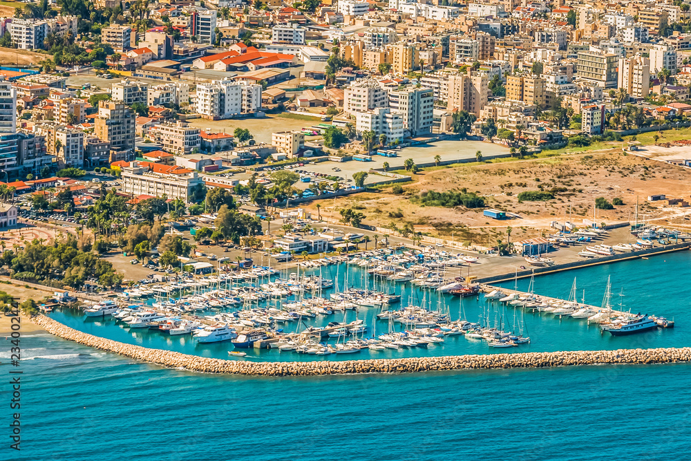 Sea port city of Larnaca, Cyprus. View from the aircraft to the coastline, beaches, seaport and the architecture of the city of Larnaca.