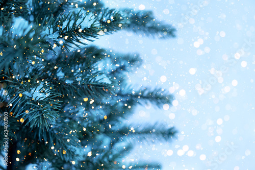 Closeup of Christmas tree with light, snow flake. Christmas and New Year holiday background. vintage color tone.