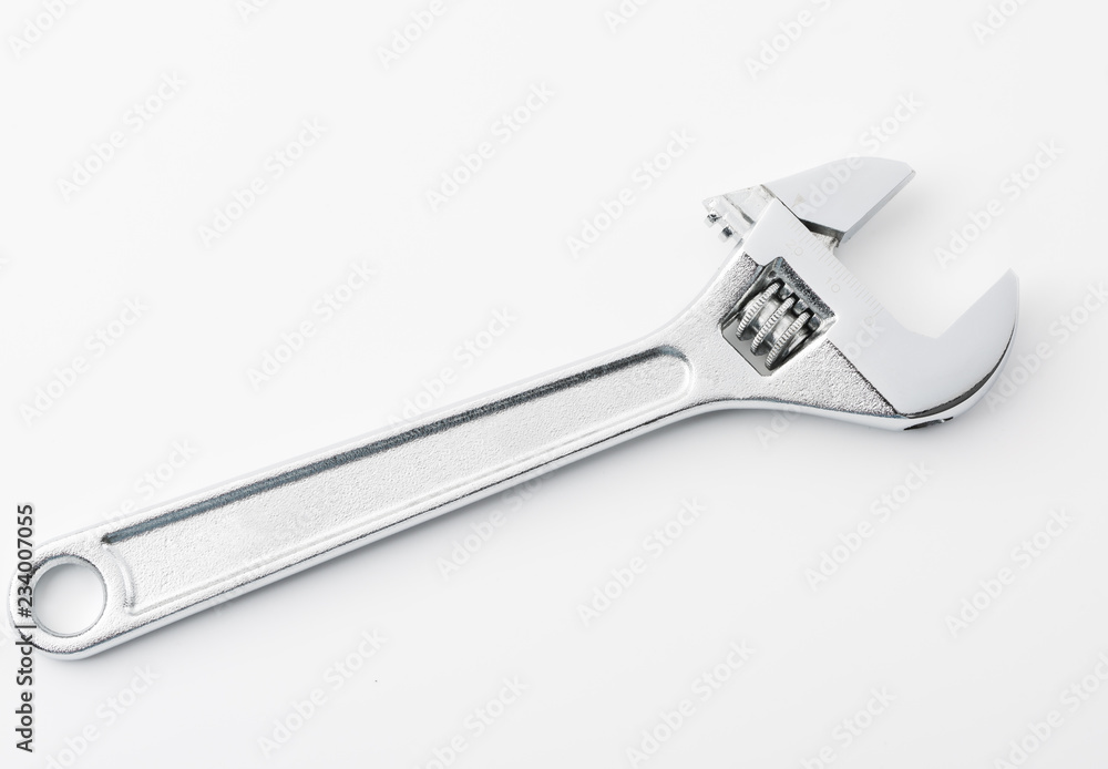 An adjustable crescent wrench tool on a white background An adjustable crescent wrench tool on a white background