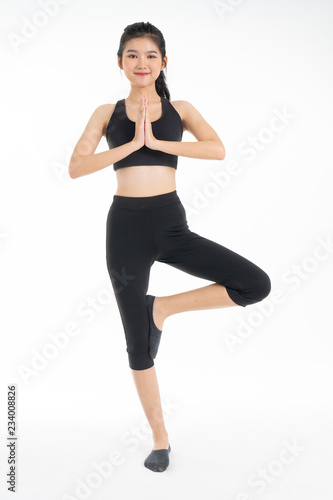 Sporty young asian woman doing yoga practice isolated on white background - concept healthy life fitness for slim.