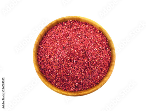 Ground Sumac Spice in Wooden Bowl. Isolated on White Background. photo