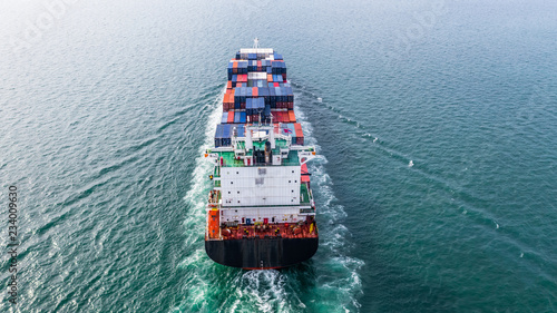 Aerial view cargo container ship sailing, container cargo ship in import export and business logistic and transportation of international by container ship in the open sea.