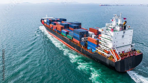 Aerial view cargo container ship sailing, container cargo ship in import export and business logistic and transportation of international by container ship, view from above business background. photo
