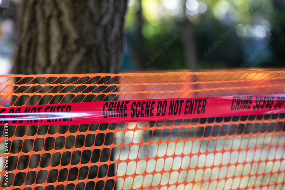 Red police tape with "Crime scene do not enter" written on it. Stock Photo Adobe Stock