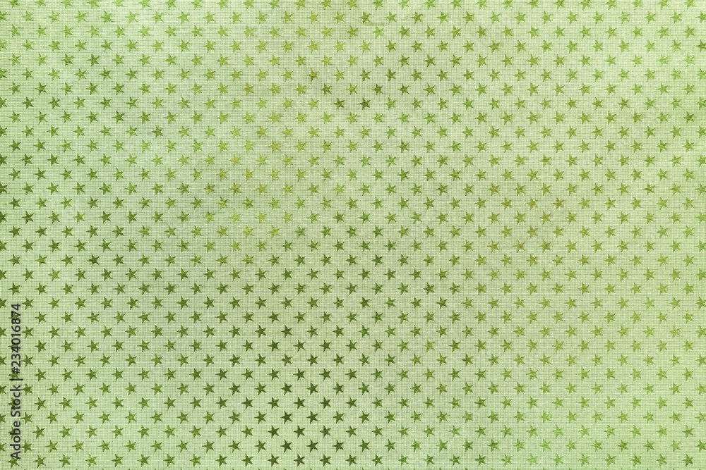 Light green background from metal foil paper with a stars pattern