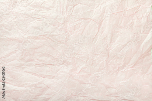 Texture of crumpled white wrapping paper, closeup. Coral old background.