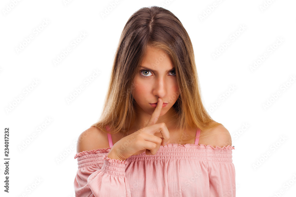 Young beautiful little girl has put forefinger to lips as sign of silence