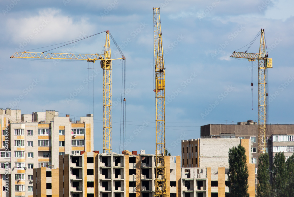 Cranes at the construction of multi-storey buildings
