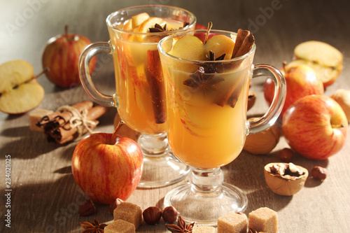 Two cups with hot cider in cold season with cinnamon and anise