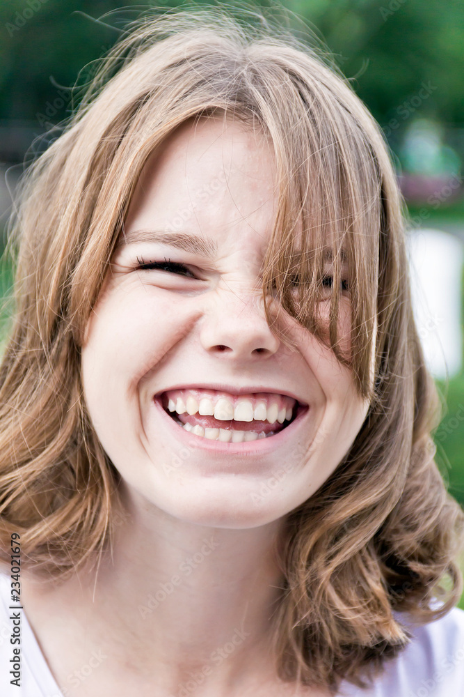 Fototapeta premium Laugh blond girl fourteen years old