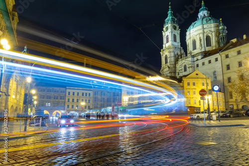 view on baroque church and night traffic in Prague, Czech republic
