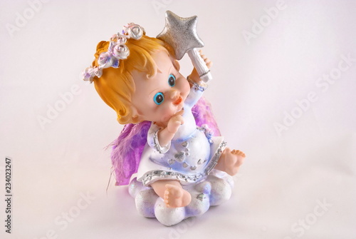 Figurine of a cute funny angel with a Christmas star in his hand.(Not the author's work. Consumer goods, stamping)