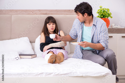 Caring husband looking after his injured wife