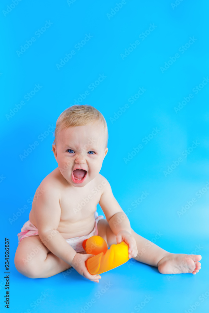 Happy baby holding yellow duck toy. Bathing concept. Children toys. Copy space. Happy baby holding yellow duck toy. Bathing concept. Children toys. Copy space.