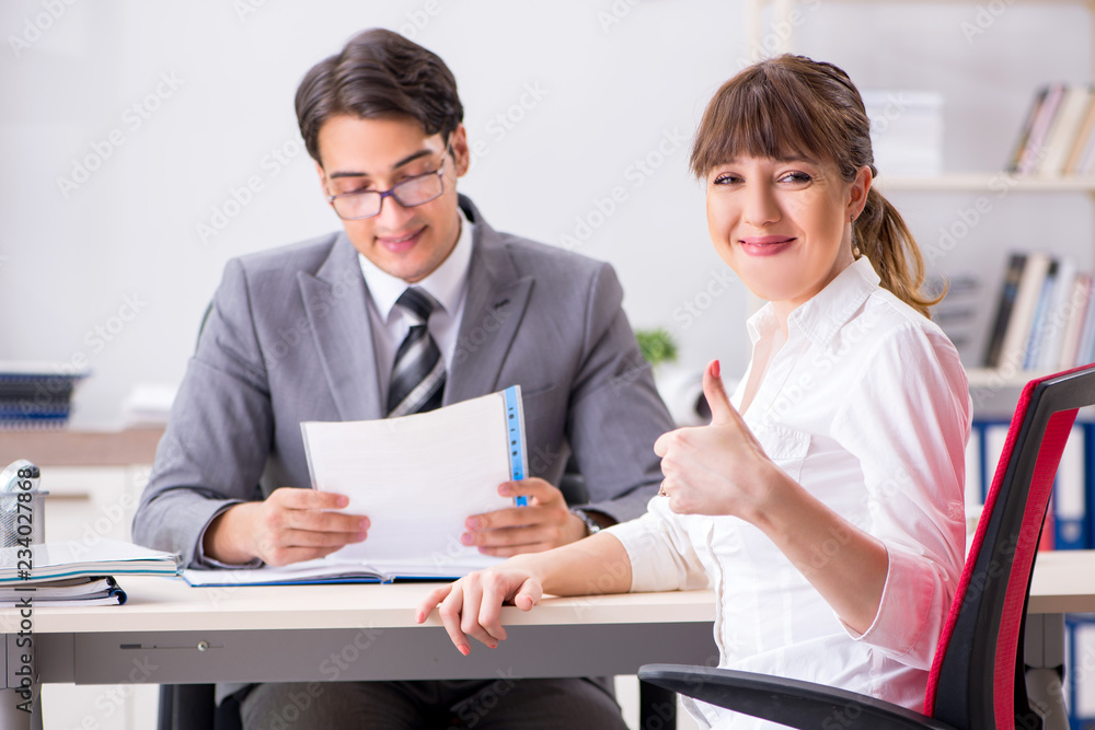 Man and woman discussing in office Man and woman discussing in office
