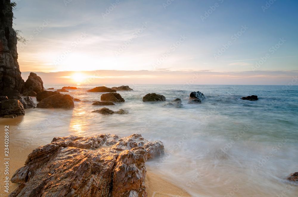 Obraz premium Travel and leisure concept, beautiful sea view scenery over stunning sunrise background.sunlight beam and soft wave hitting sandy beach