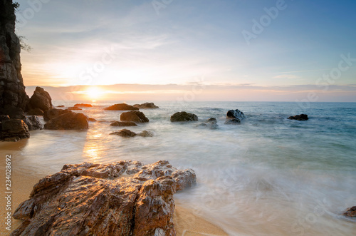 Travel and leisure concept, beautiful sea view scenery over stunning sunrise background.sunlight beam and soft wave hitting sandy beach