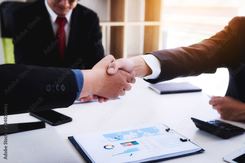 Business people shaking hands after finishing up a meeting good teamwork in office.Teamwork successful Meeting Workplace strategy Concept. Business people shaking hands after finishing up a meeting good teamwork in office.Teamwork successful Meeting Workplace strategy Concept.