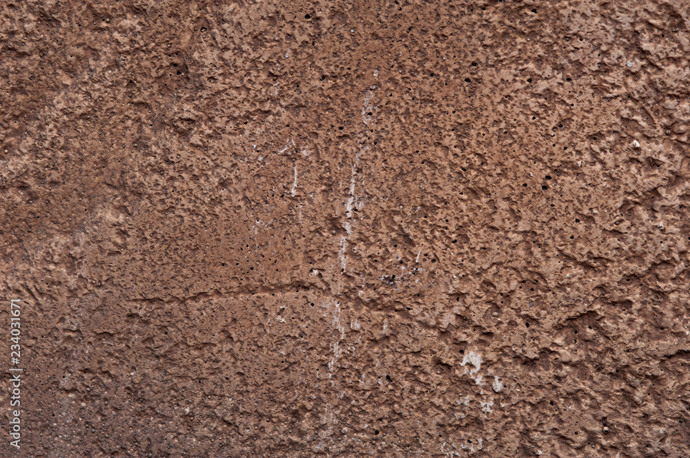 The texture of rough brown stone rock. Natural design element for any purpose. Surface of the rock with brown tint