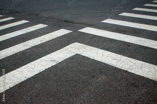 zebra crossing on asphalt pavement, closeup photo