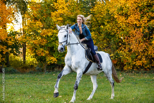 Woman riding a horse in park © Jacek Chabraszewski