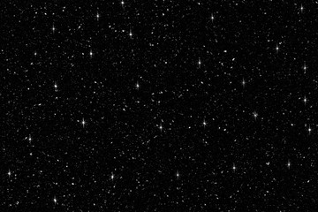 Falling snow with shine glitter on black background. Winter background in pure dark. Heavy snow.