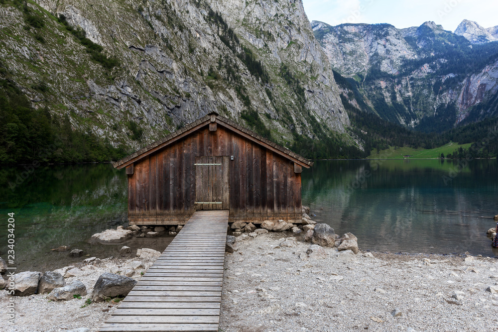Beautiful view of traditional wooden boat house at the shores of famous Lake Obersee in scenic Nationalpark Berchtesgadener Land on a sunny day in summer, Bavaria, Germany Beautiful view of traditional wooden boat house at the shores of famous Lake Obersee in scenic Nationalpark Berchtesgadener Land on a sunny day in summer, Bavaria, Germany