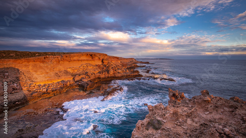 Evening golden sunlight reflecting off the sea cliffs on Dirk Hartog Island, Western Australia