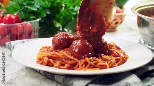 Serving spaghetti with meatballs in tomato sauce