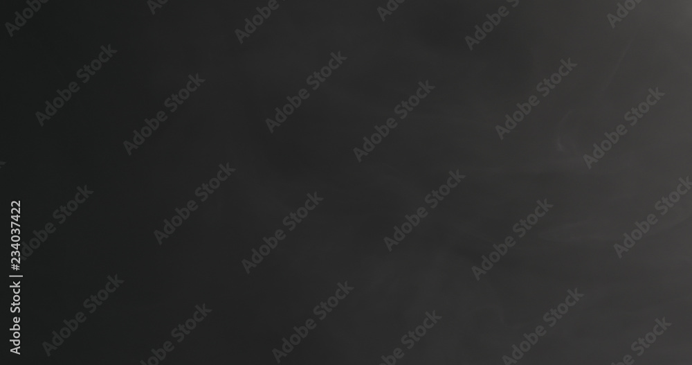 Slow motion closeup vapor floating in air on black background Slow motion closeup vapor floating in air on black background