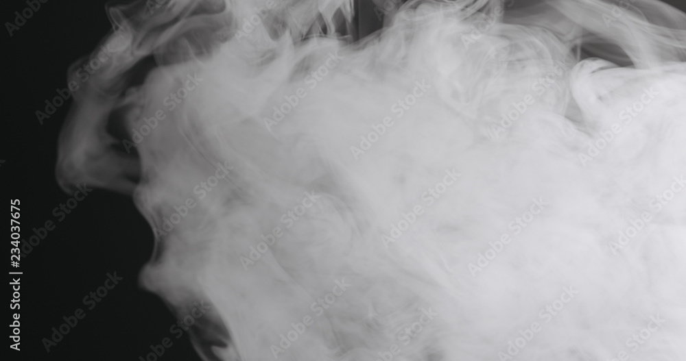 Slow motion closeup vapor floating in air on black background