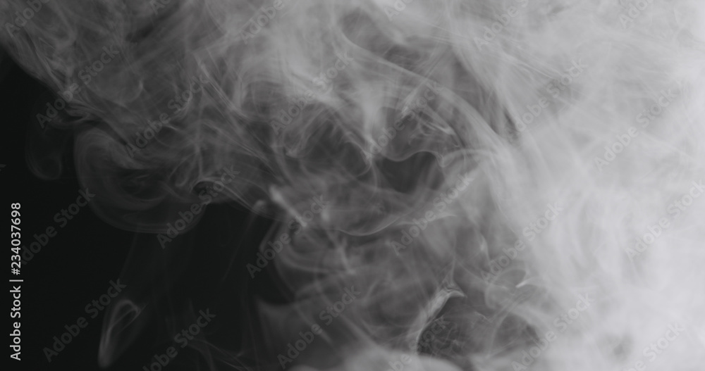 Slow motion closeup vapor floating in air on black background Slow motion closeup vapor floating in air on black background