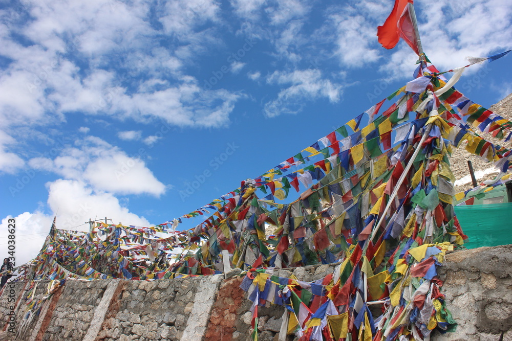buddhist prayer flags on hilltop