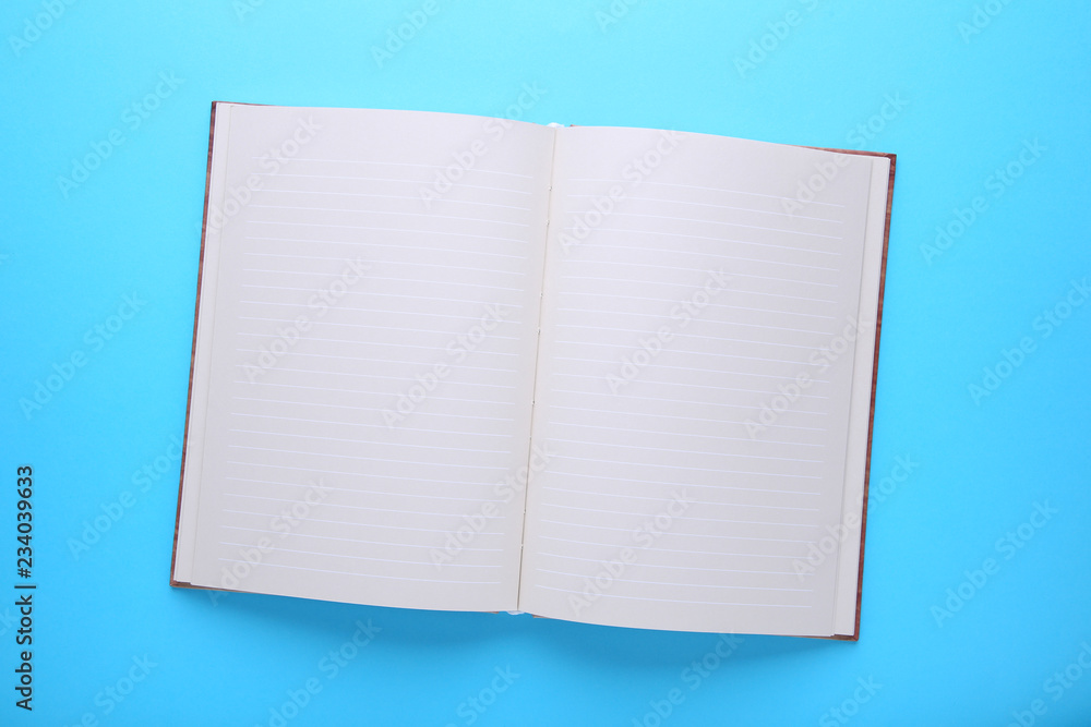 Notebook on a blue background, close up
