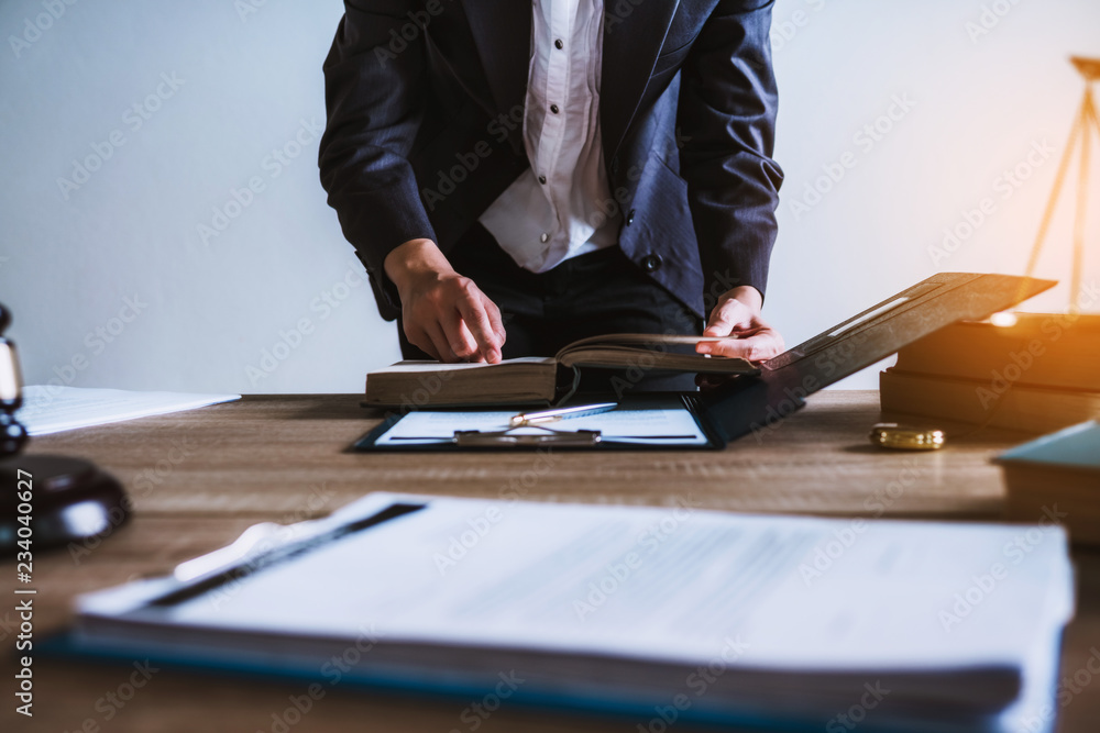 Women lawyer working with contract papers and wooden gavel on tabel in courtroom. justice and law ,attorney, court judge, concept. Women lawyer working with contract papers and wooden gavel on tabel in courtroom. justice and law ,attorney, court judge, concept.