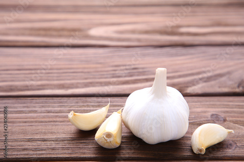 Fresh garlic on a brown wooden background