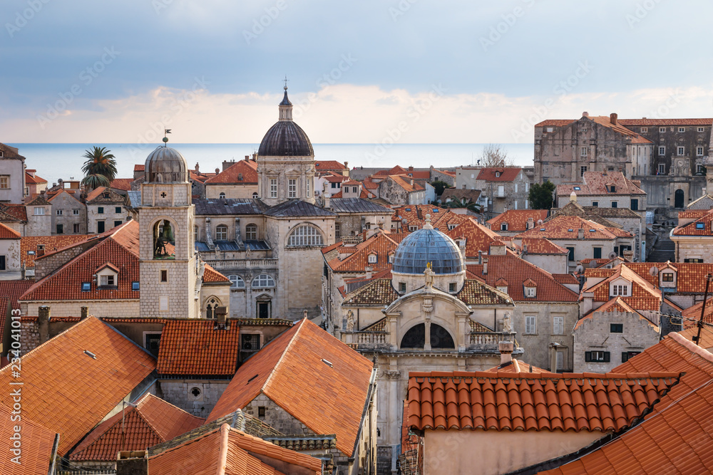 View over the orange roofs of old town Dubrovnik with church towers and ocean in winter, Croatia